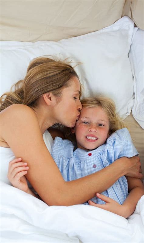 mother kissing her daughter images